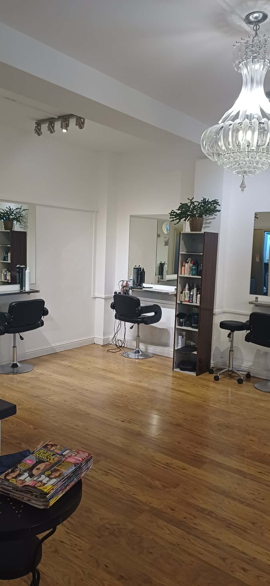 Bright salon interior with styling chairs and chandelier